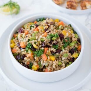 Farro grains mixed with colorful vegetables in a bowl