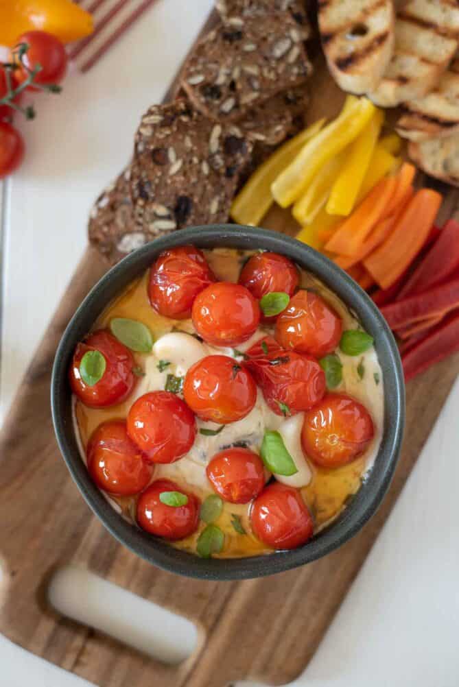 Sweet braised tomatoes served over whipped ricotta and goat cheese with fresh basil