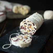 A white chocolate log studded inside with nuts, and dried cranberries