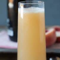 A white peach Bellini drink viewed from the side