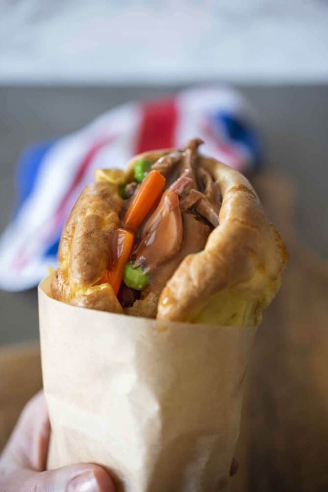 Holding a Yorkshire pudding wrap with parchment paper