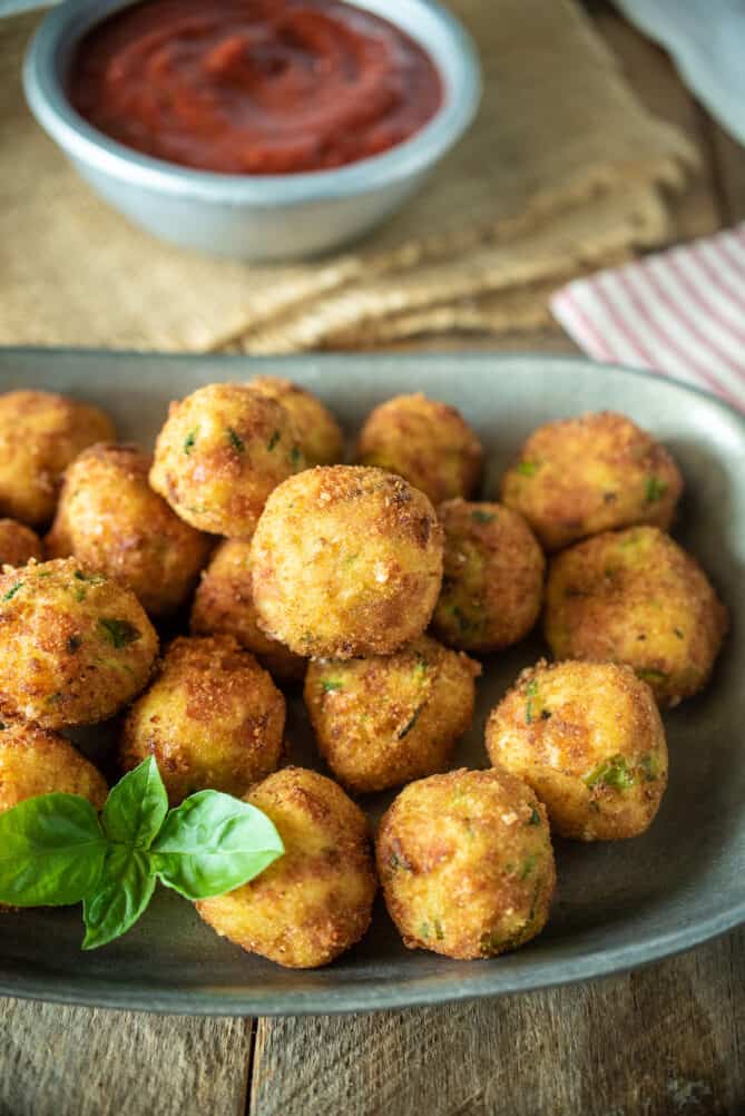 Zucchini and mortadella balls breaded with tomato sauce