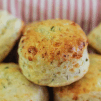 A browned scone with flecks of green chives