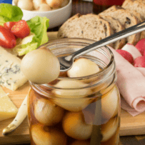 A Mason jar of malt vinegar and small onions