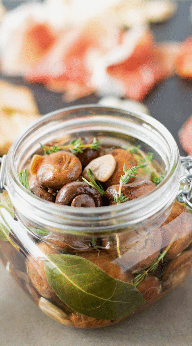 Herbs and garlic with mushrooms in a glass jar