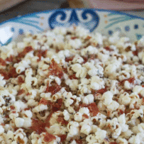 Freshly popped popcorn with Parmesan cheese and crispy prosciutto