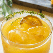 A refreshing mango coconut mocktail served with ice in a glass