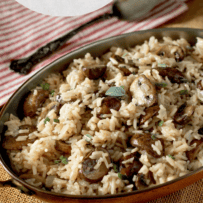 Mushroom rice pilaf in an oval bowl with a spoon