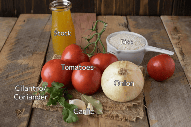 A bottle of broth, white rice, tomatoes, onion, garlic and cilantro